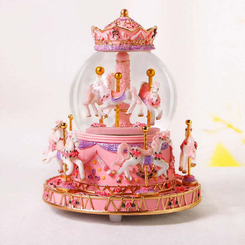 Decorative music box with snow globe and carousel