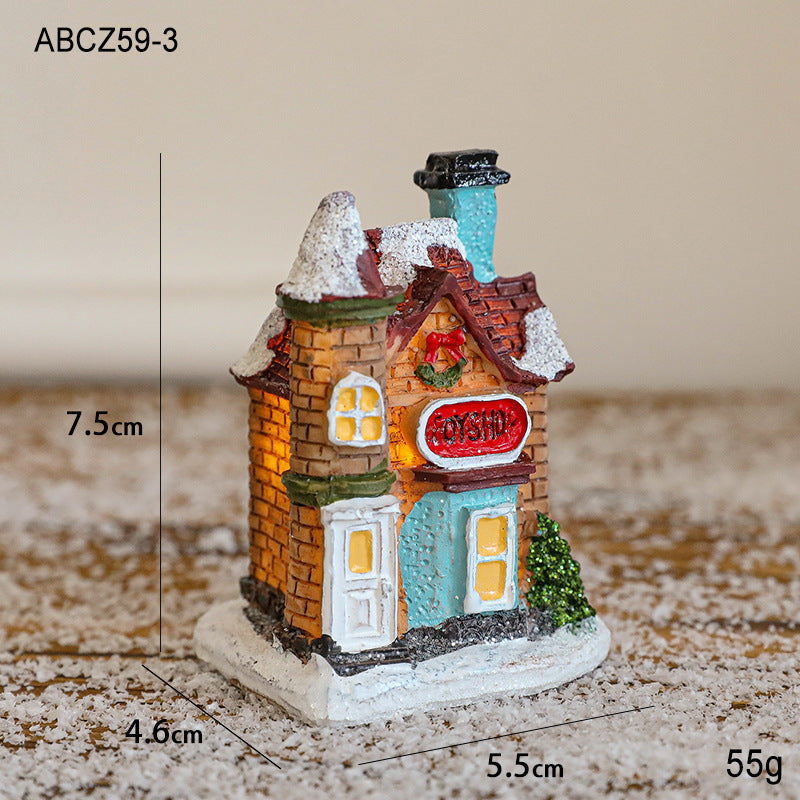 Illuminated Christmas house made of resin for table decoration