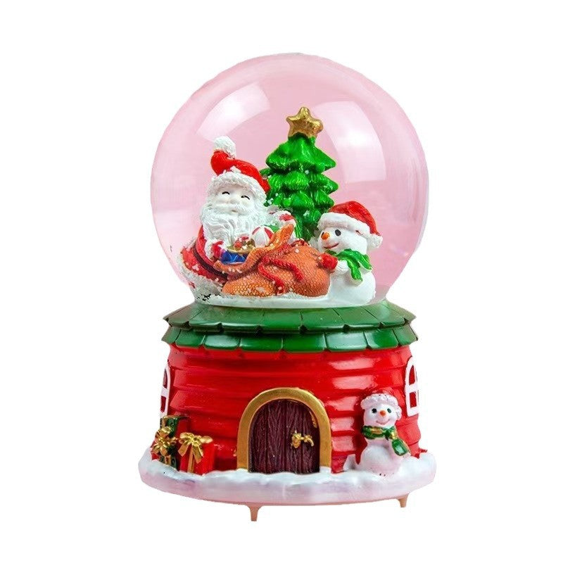 Illuminated snow globe music box, resin