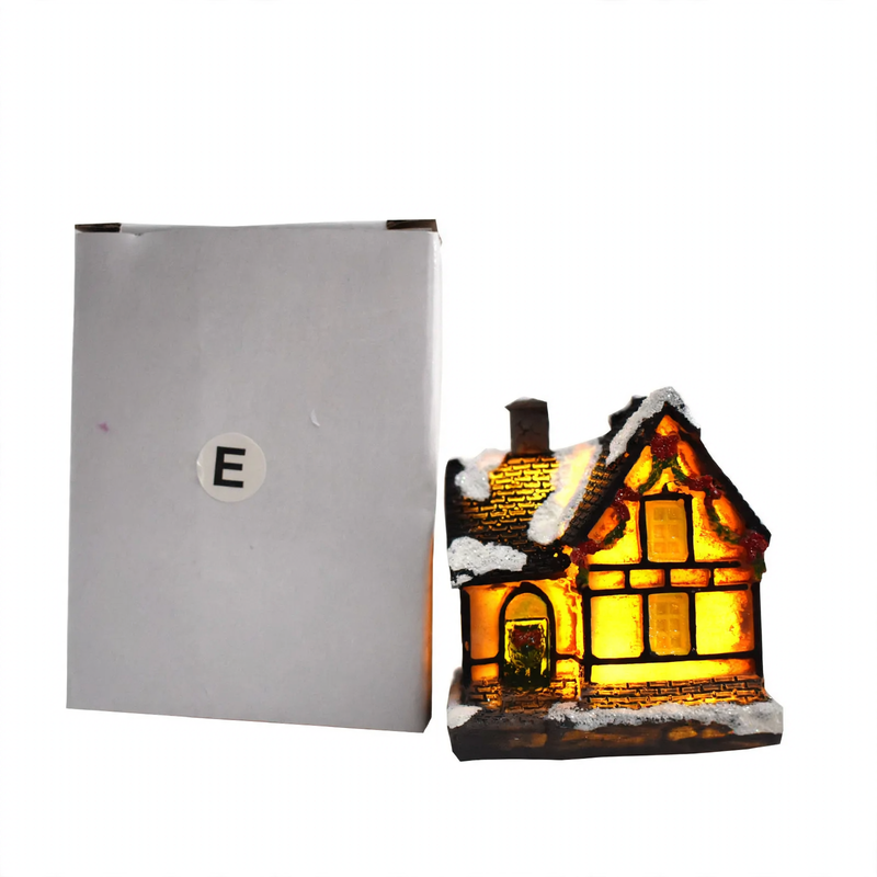 Illuminated Christmas house made of resin with snow effect