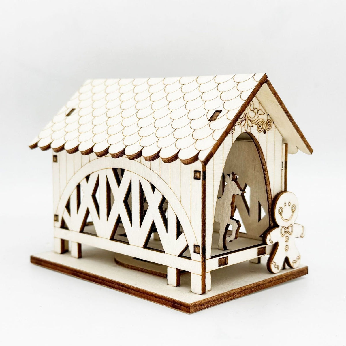 Illuminated wooden house with bridge