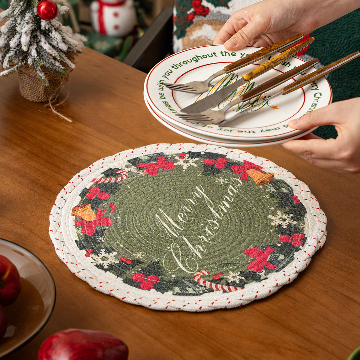 Round Christmas tree skirt made of woven cotton blend fabric with reindeer and pine branch motif