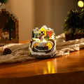 Illuminated Christmas village scene with snowman Yeouu
